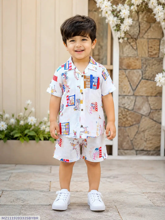 Child wearing a colorful outfit standing outdoors with flowers and a stone wall in the background