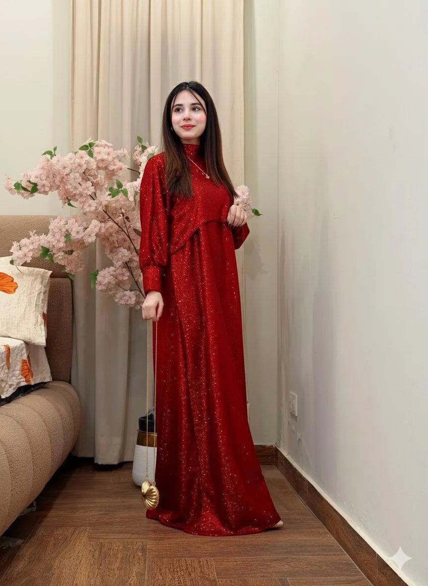 Woman in a red dress standing in a room with floral decorations.