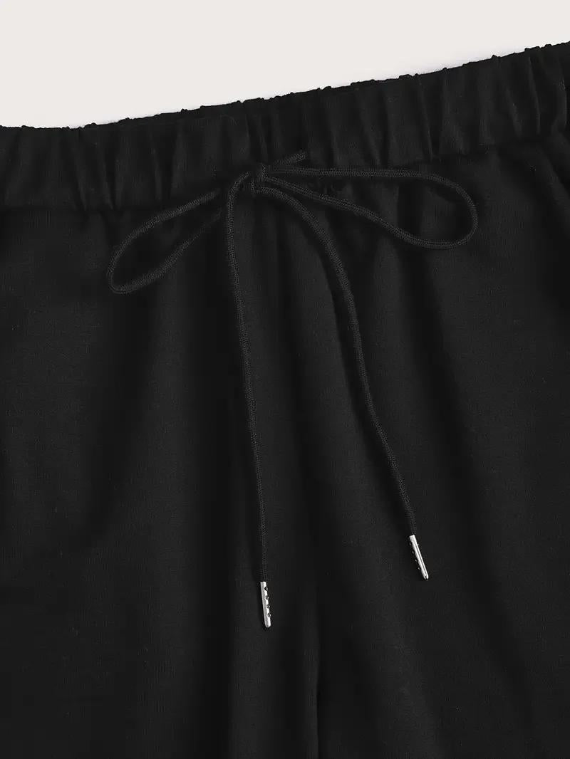 Black pants with drawstring waist on a light gray background
