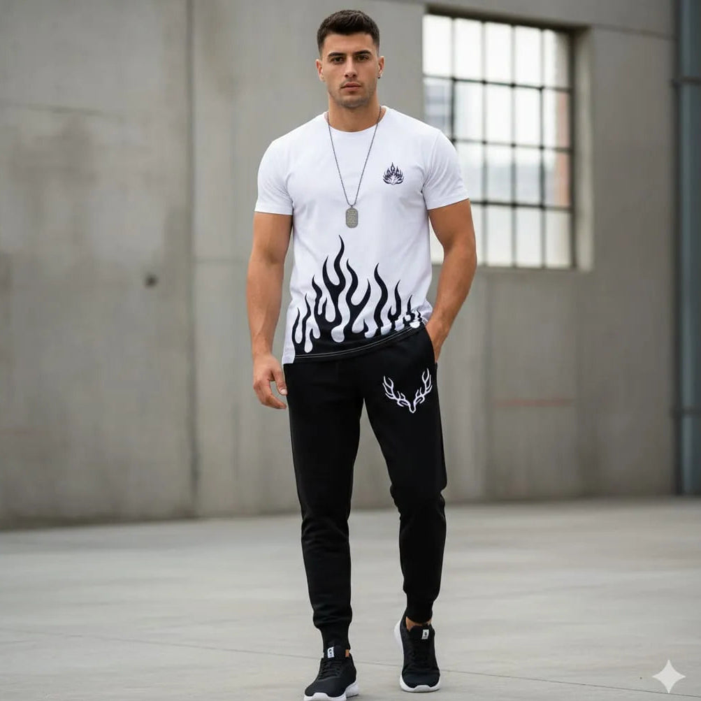 Man wearing a white t-shirt with flame design and black pants in an urban setting